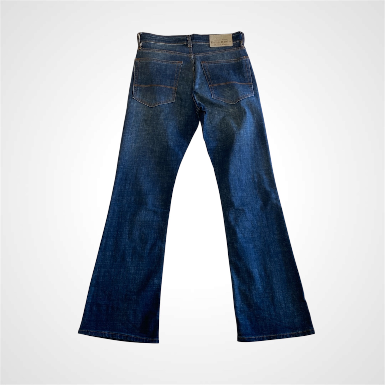 Back view of Ikson vintage tint bootcut jeans for men with clean pocket design and bootcut leg opening.